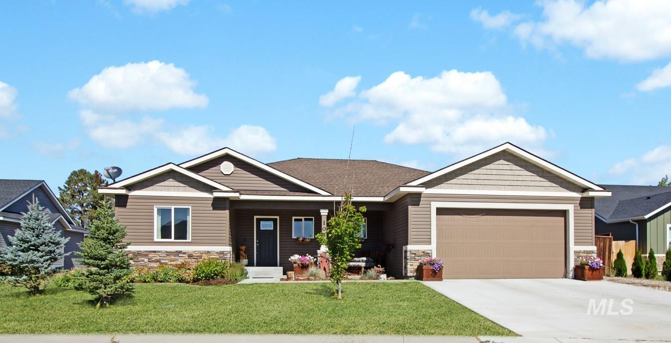 Craftsman inspired home featuring stone siding, a front lawn, driveway, an attached garage, and a porch