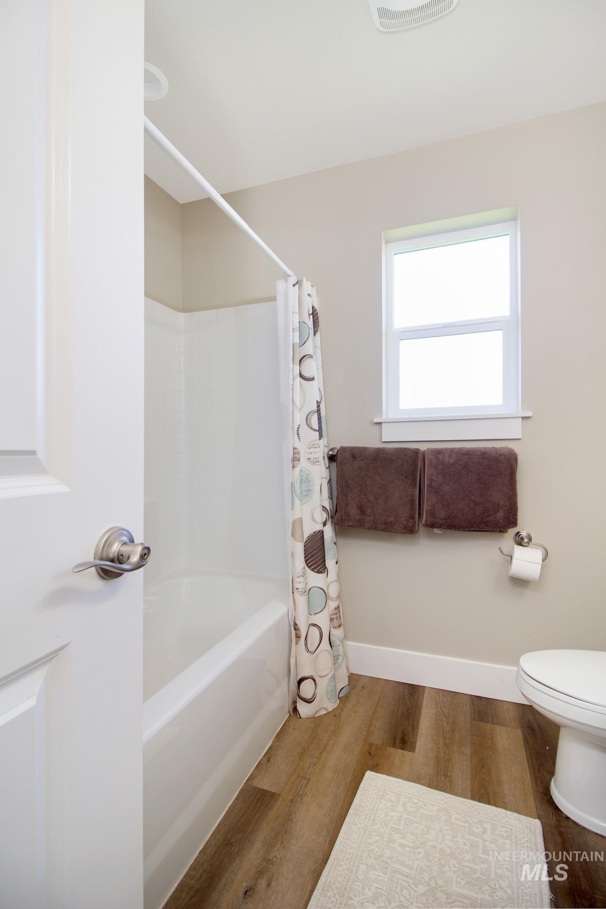 105 Greenfield Way Madison, MS 39110 - Photo 10 of 24 Bathroom with wood finished floors and shower / bath combination with curtain
