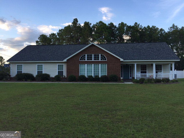 295 Corey Street Baxley, GA 31513 - Photo 1 of 1 a front view of a house with a garden