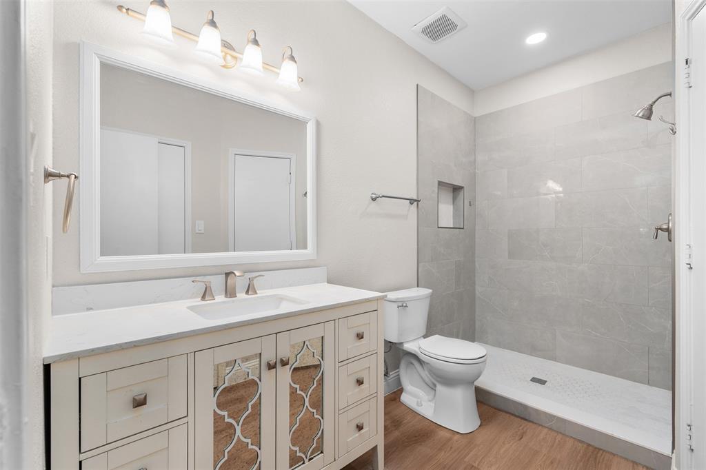 2906 Roxboro Road Euless, TX 76039 - Photo 12 of 23 a bathroom with a sink a toilet and shower