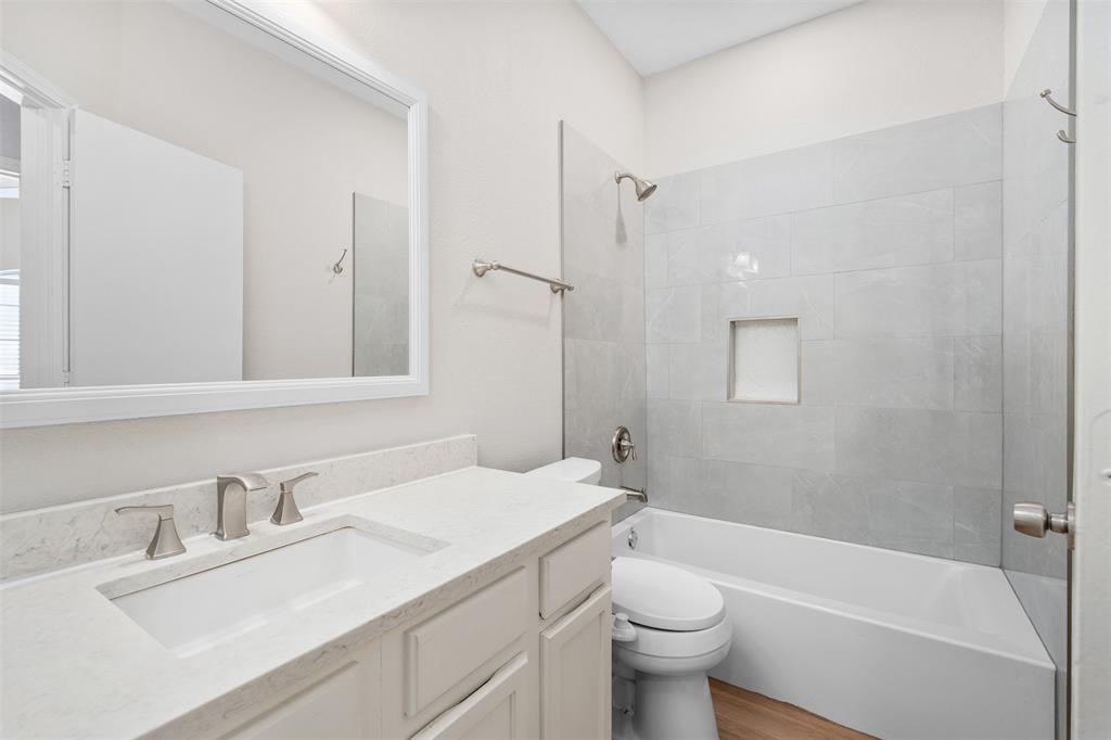 2906 Roxboro Road Euless, TX 76039 - Photo 16 of 23 a bathroom with a sink a toilet and shower