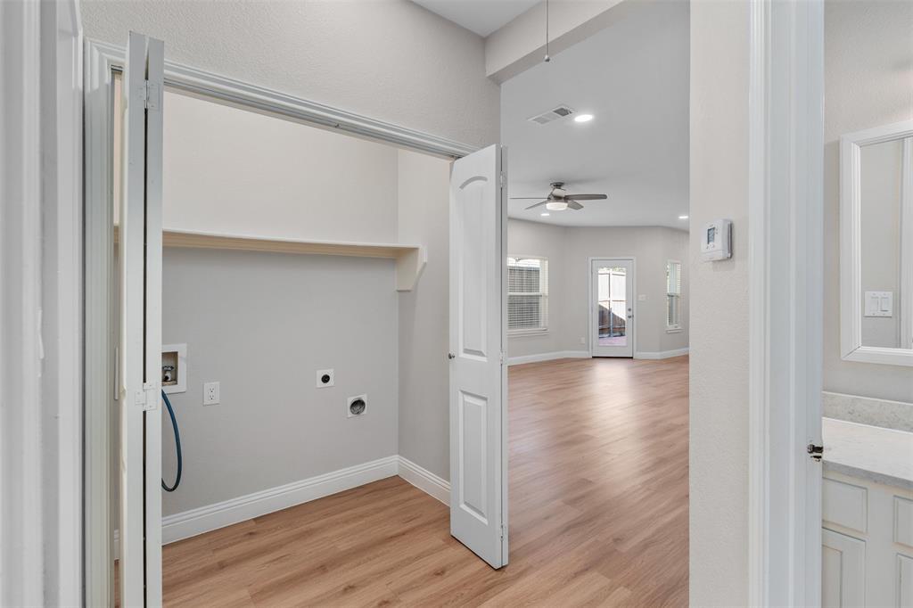 2906 Roxboro Road Euless, TX 76039 - Photo 17 of 23 a view of a hallway with wooden floor