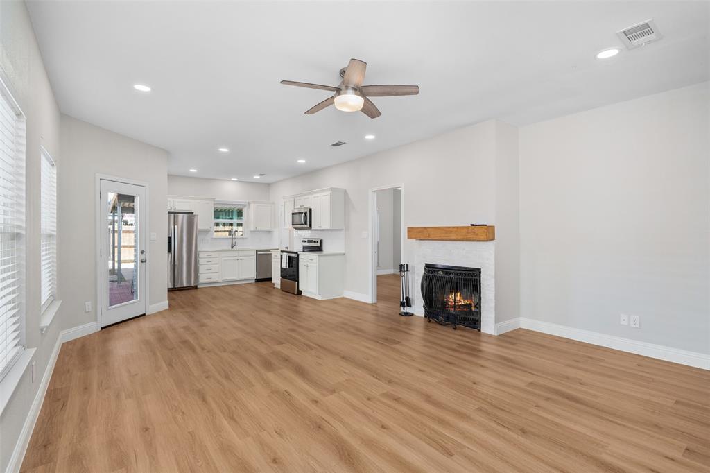 2906 Roxboro Road Euless, TX 76039 - Photo 6 of 23 a view of an empty room with window and fire place