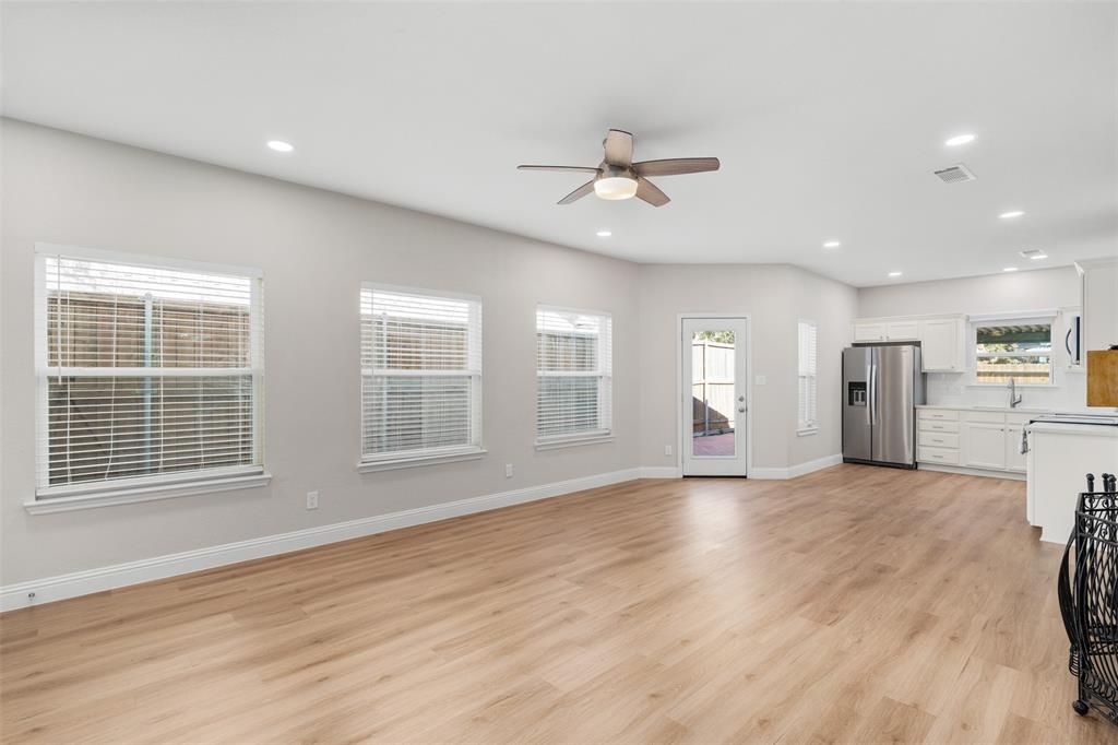 2906 Roxboro Road Euless, TX 76039 - Photo 7 of 23 a view of an empty room with a window and wooden floor