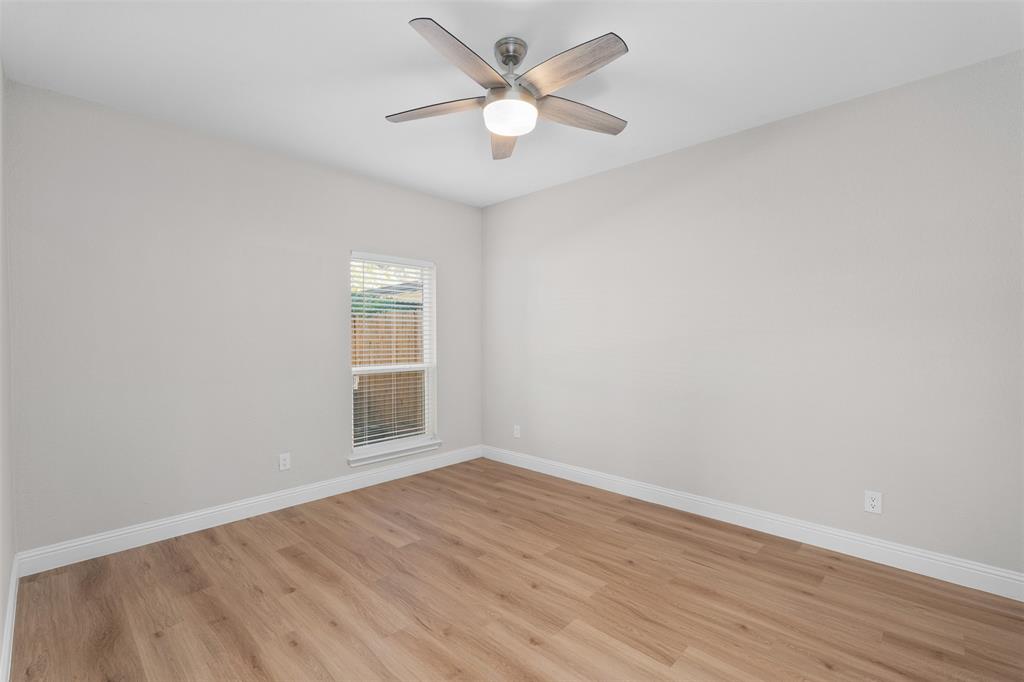 2906 Roxboro Road Euless, TX 76039 - Photo 10 of 23 wooden floor in an empty room with a window