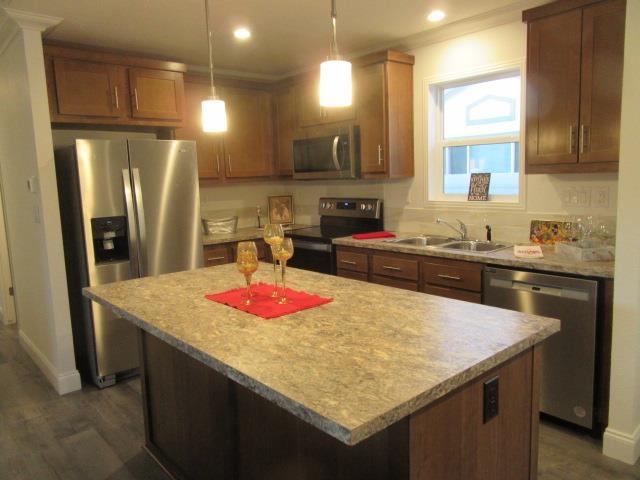 222 Holly Berry Way Fruita, CO 81521 - Photo 15 of 23 a kitchen with stainless steel appliances granite countertop kitchen island a sink refrigerator and cabinets