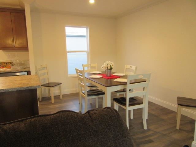222 Holly Berry Way Fruita, CO 81521 - Photo 16 of 23 a view of a dining room with furniture and wooden floor