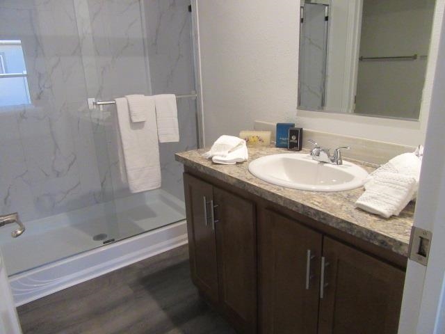 222 Holly Berry Way Fruita, CO 81521 - Photo 18 of 23 a bathroom with a granite countertop sink a mirror and a bathtub