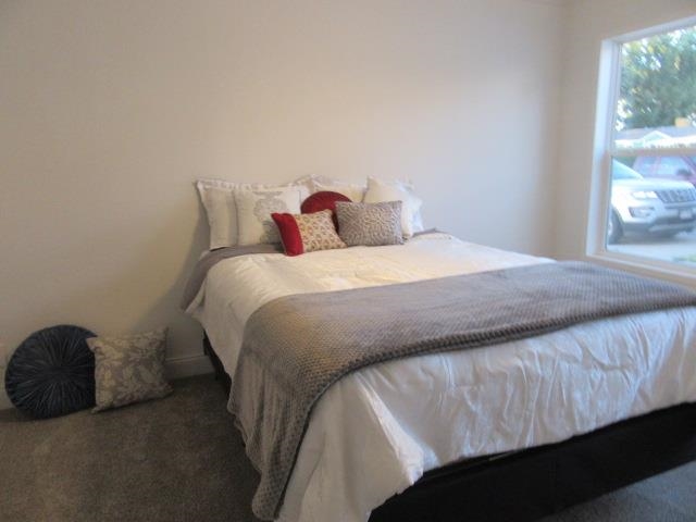 222 Holly Berry Way Fruita, CO 81521 - Photo 19 of 23 a bedroom with a bed and window
