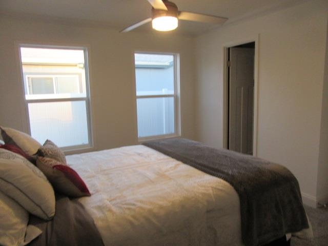 222 Holly Berry Way Fruita, CO 81521 - Photo 22 of 23 a bedroom with a bed and a window