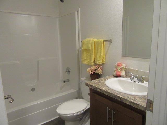 222 Holly Berry Way Fruita, CO 81521 - Photo 23 of 23 a bathroom with a granite countertop sink toilet and shower