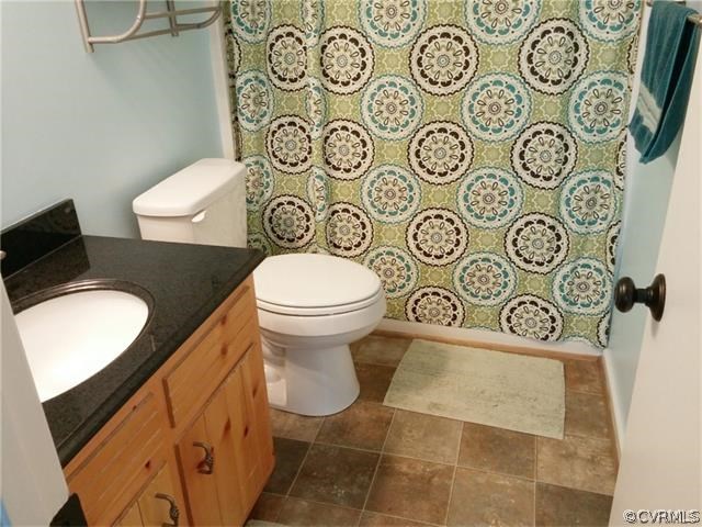 2528 London Road Henrico, VA 23233 - Photo 6 of 10 a bathroom with a toilet and a shower curtain