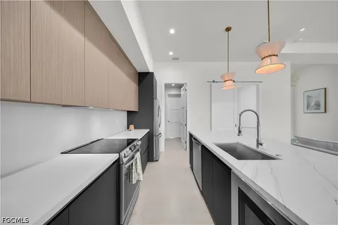 a kitchen with sink stove and white cabinets