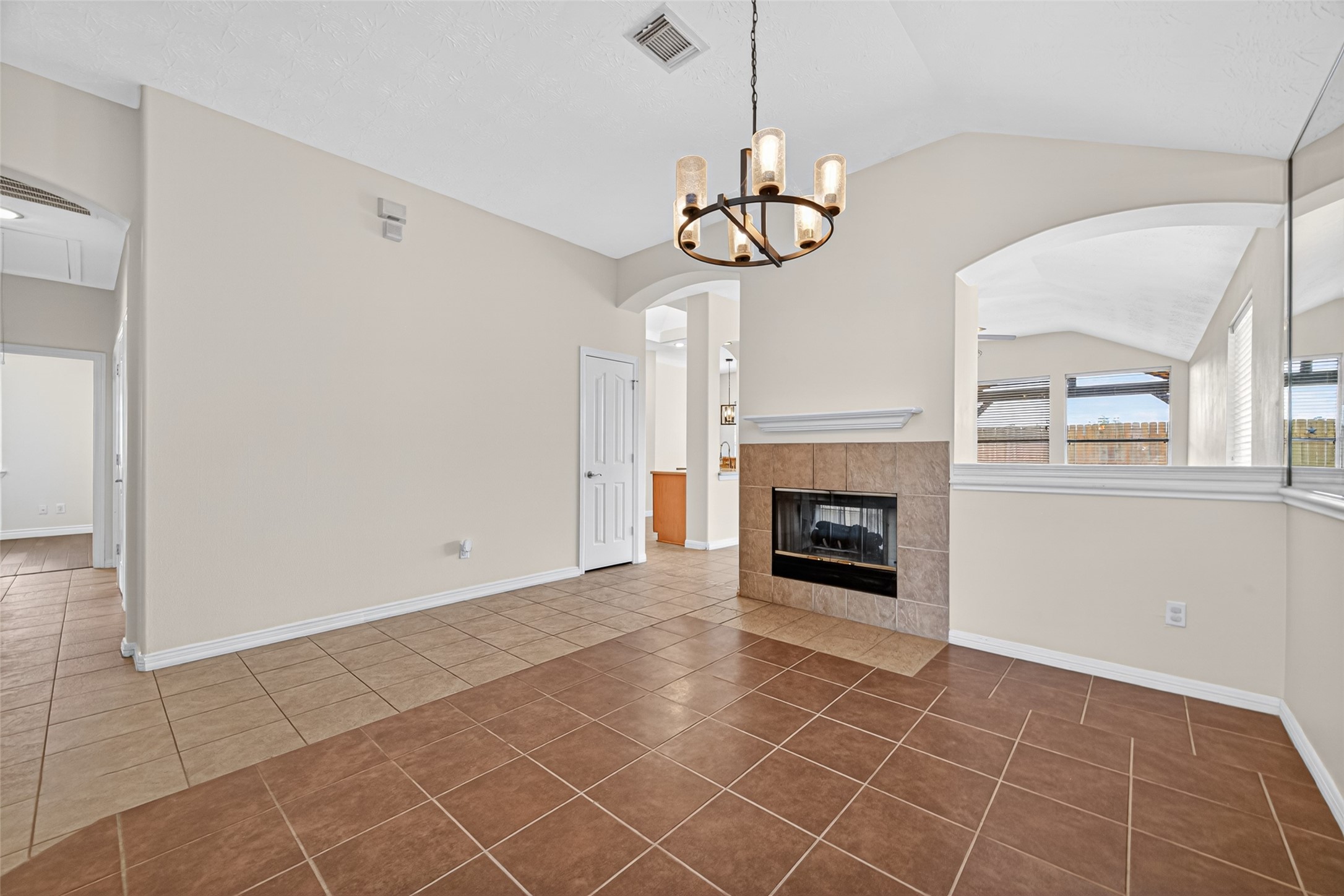 23914 Glengate Drive Spring, TX 77373 - Photo 8 of 49 a view of a livingroom with a fireplace a chandelier and stairs