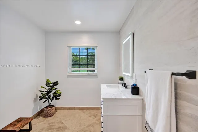 a bathroom with a sink vanity granite and a mirror