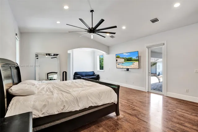 a bedroom with a bed and a flat screen tv