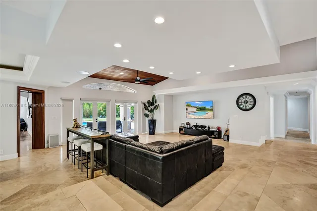a kitchen with a sink dishwasher and white cabinets with wooden floor