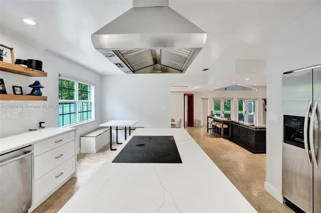 a bathroom with a granite countertop sink a mirror and shower