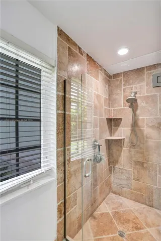 a view of a hallway with wooden floor and a cabinet