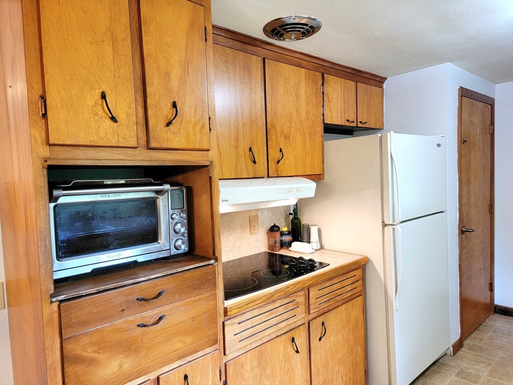 2022 Quaboag Street Three Rivers, MA 01080 - Photo 6 of 16 a kitchen with stainless steel appliances granite countertop a refrigerator a stove and a sink