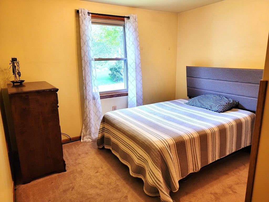 2022 Quaboag Street Three Rivers, MA 01080 - Photo 10 of 16 a bedroom with a bed and a window