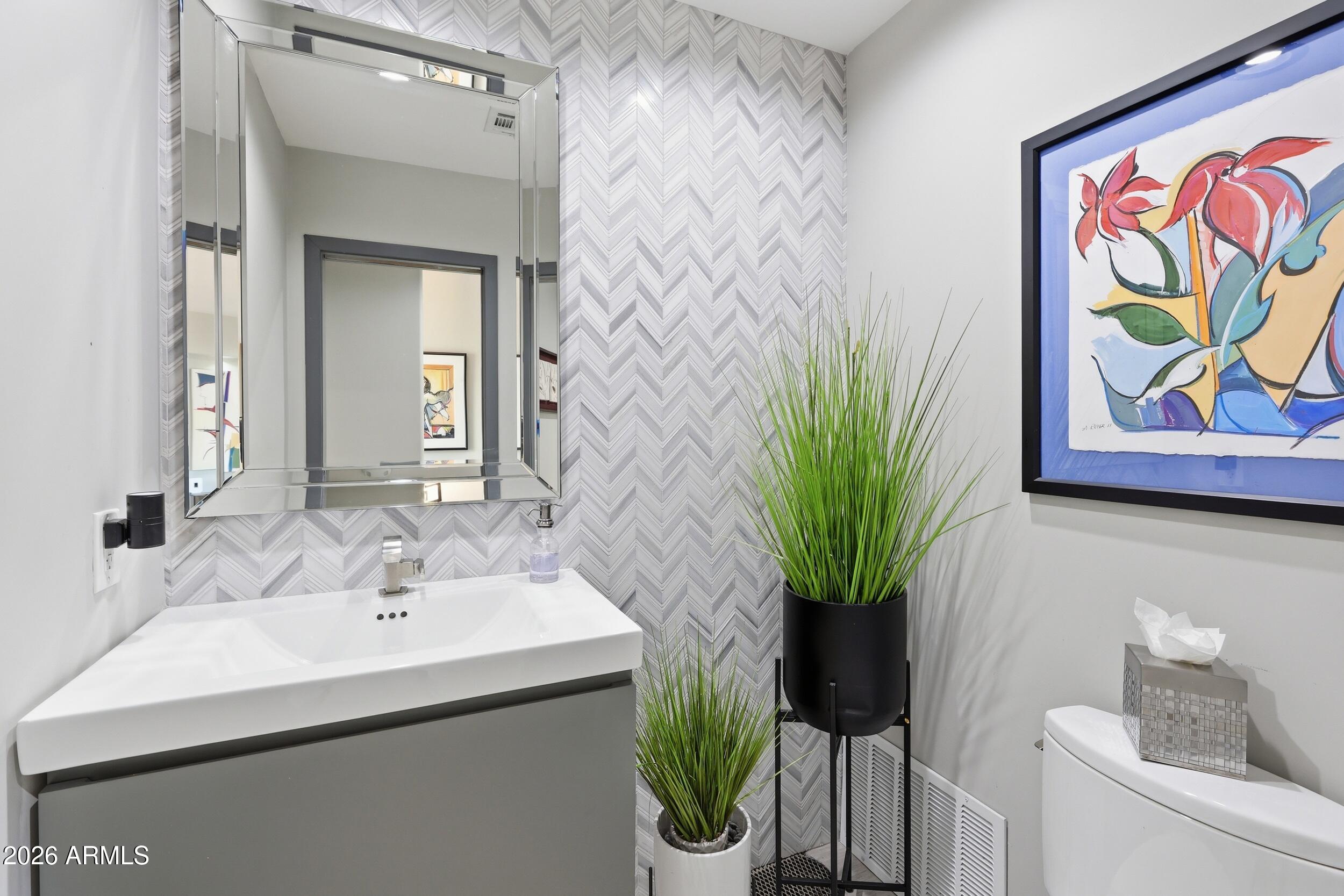 4417 East Mountain View Road Phoenix, AZ 85028 - Photo 8 of 41 a bathroom with a sink a toilet and a mirror