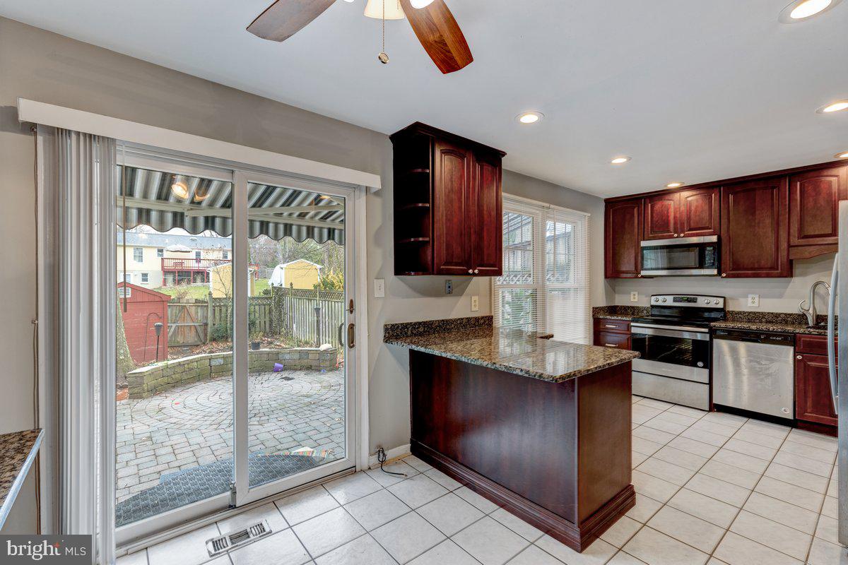 a kitchen with stainless steel appliances granite countertop a refrigerator and a stove