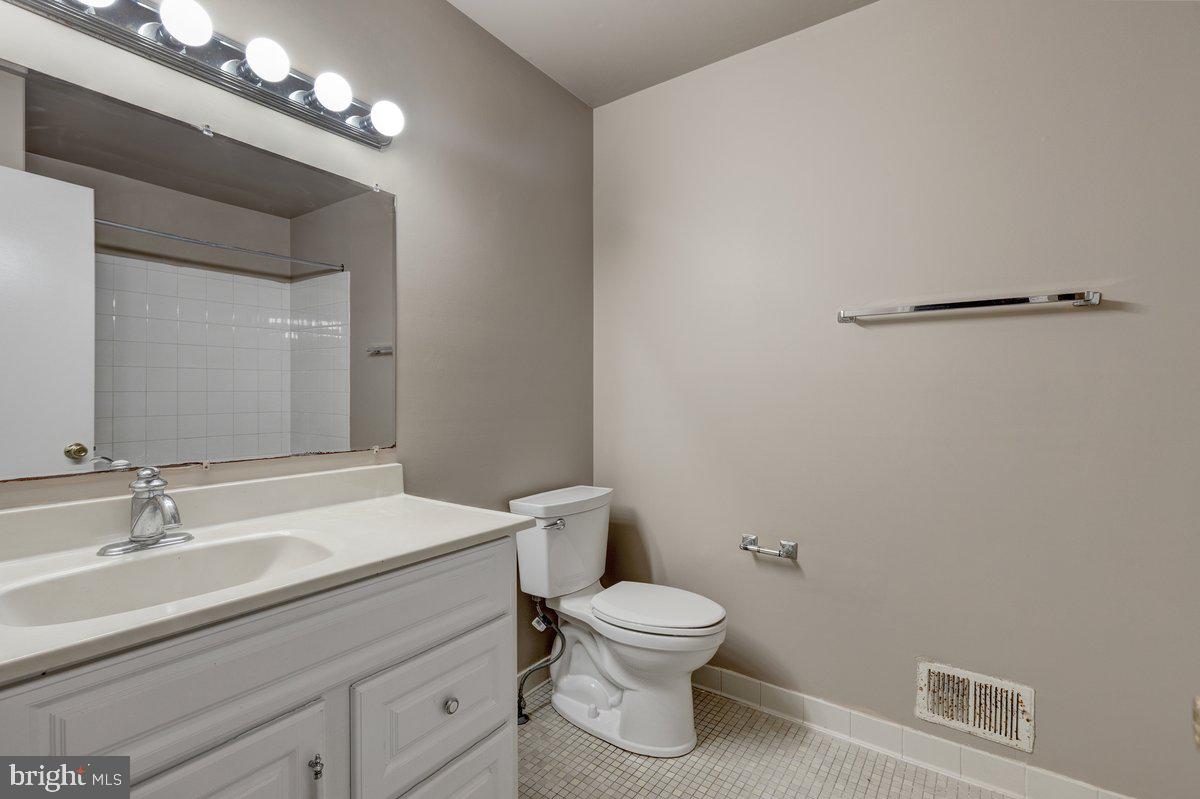 14216 Catamount Court Silver Spring, MD 20906 - Photo 11 of 30 a bathroom with a toilet a sink and mirror
