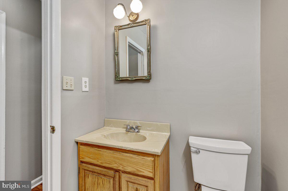 14216 Catamount Court Silver Spring, MD 20906 - Photo 18 of 30 a bathroom with a toilet sink and mirror