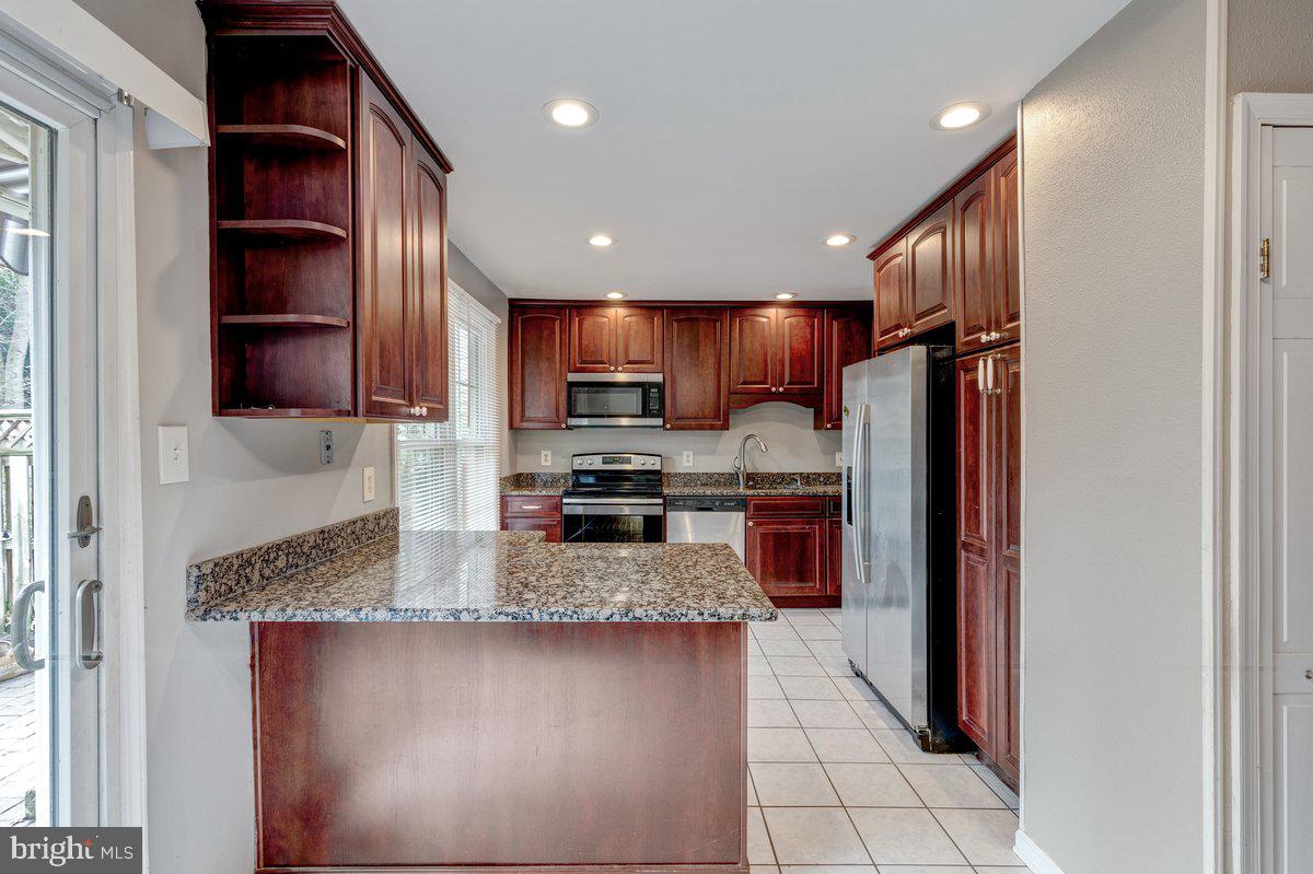 14216 Catamount Court Silver Spring, MD 20906 - Photo 2 of 30 a kitchen with stainless steel appliances granite countertop a refrigerator and a stove top oven