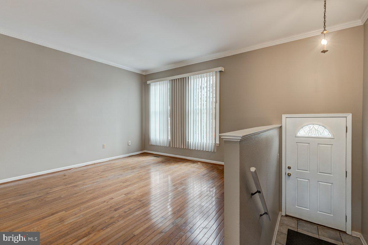 14216 Catamount Court Silver Spring, MD 20906 - Photo 22 of 30 a view of an empty room with wooden floor and a window