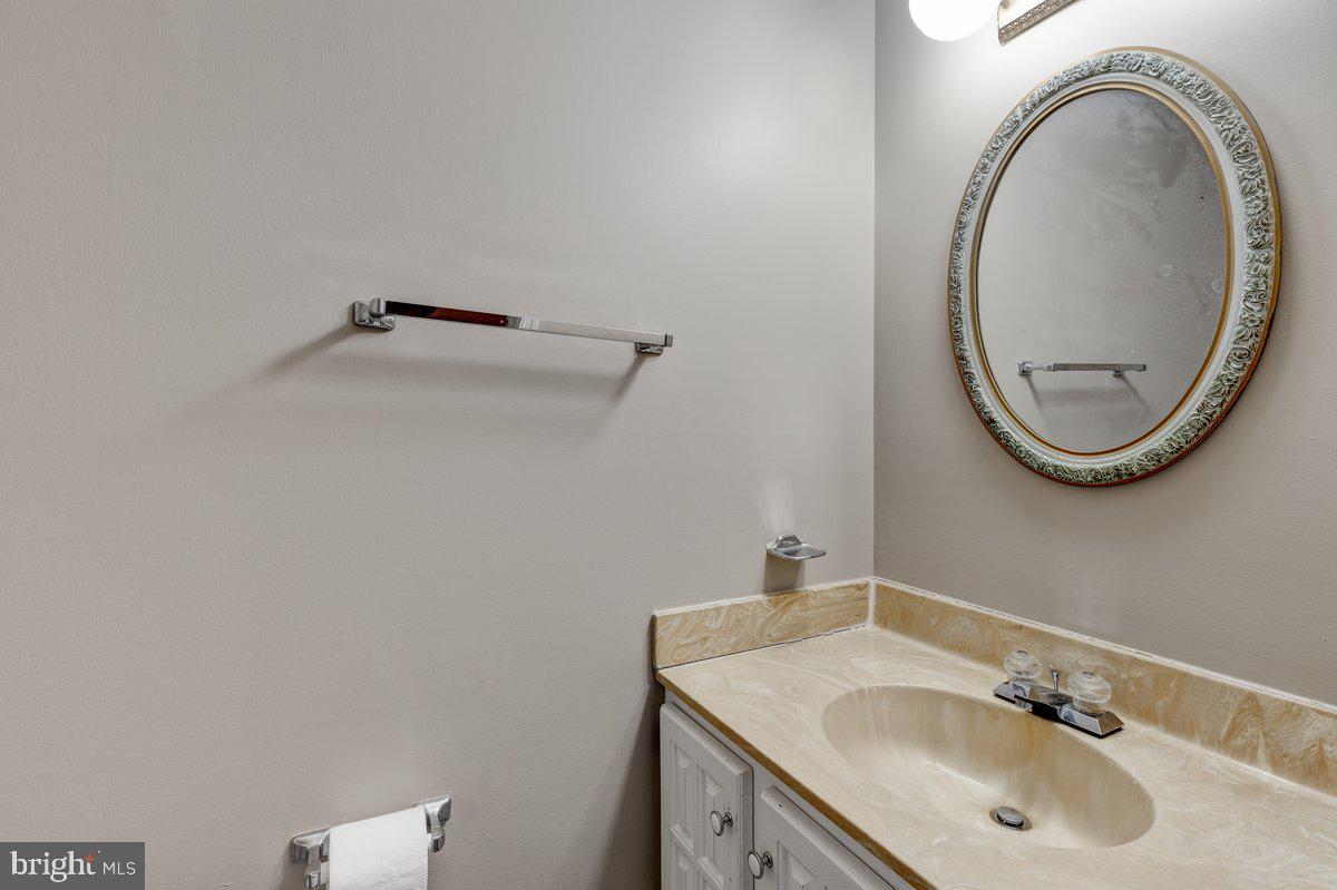 14216 Catamount Court Silver Spring, MD 20906 - Photo 24 of 30 a bathroom with a sink and a mirror