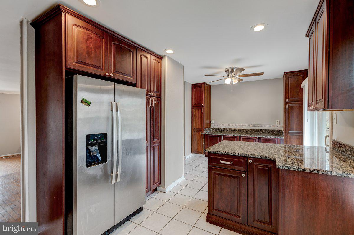 14216 Catamount Court Silver Spring, MD 20906 - Photo 3 of 30 a kitchen with stainless steel appliances granite countertop a refrigerator and a sink