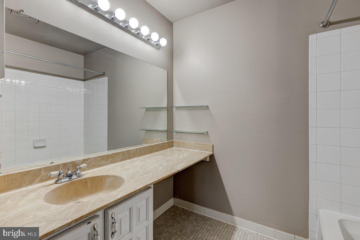 14216 Catamount Court Silver Spring, MD 20906 - Photo 8 of 30 a bathroom with a sink and a mirror
