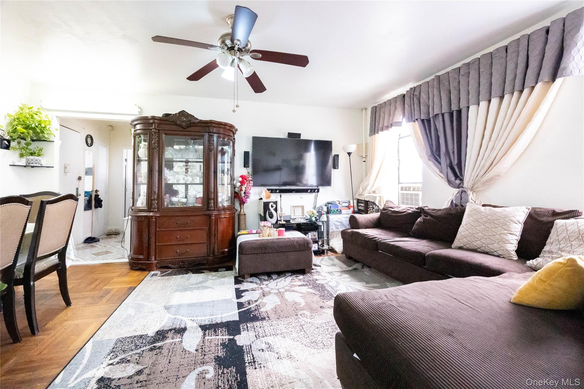 1506 Overing Street, Unit 6C Bronx, NY 10461 - Photo 5 of 16 a living room with furniture ceiling fan and a rug