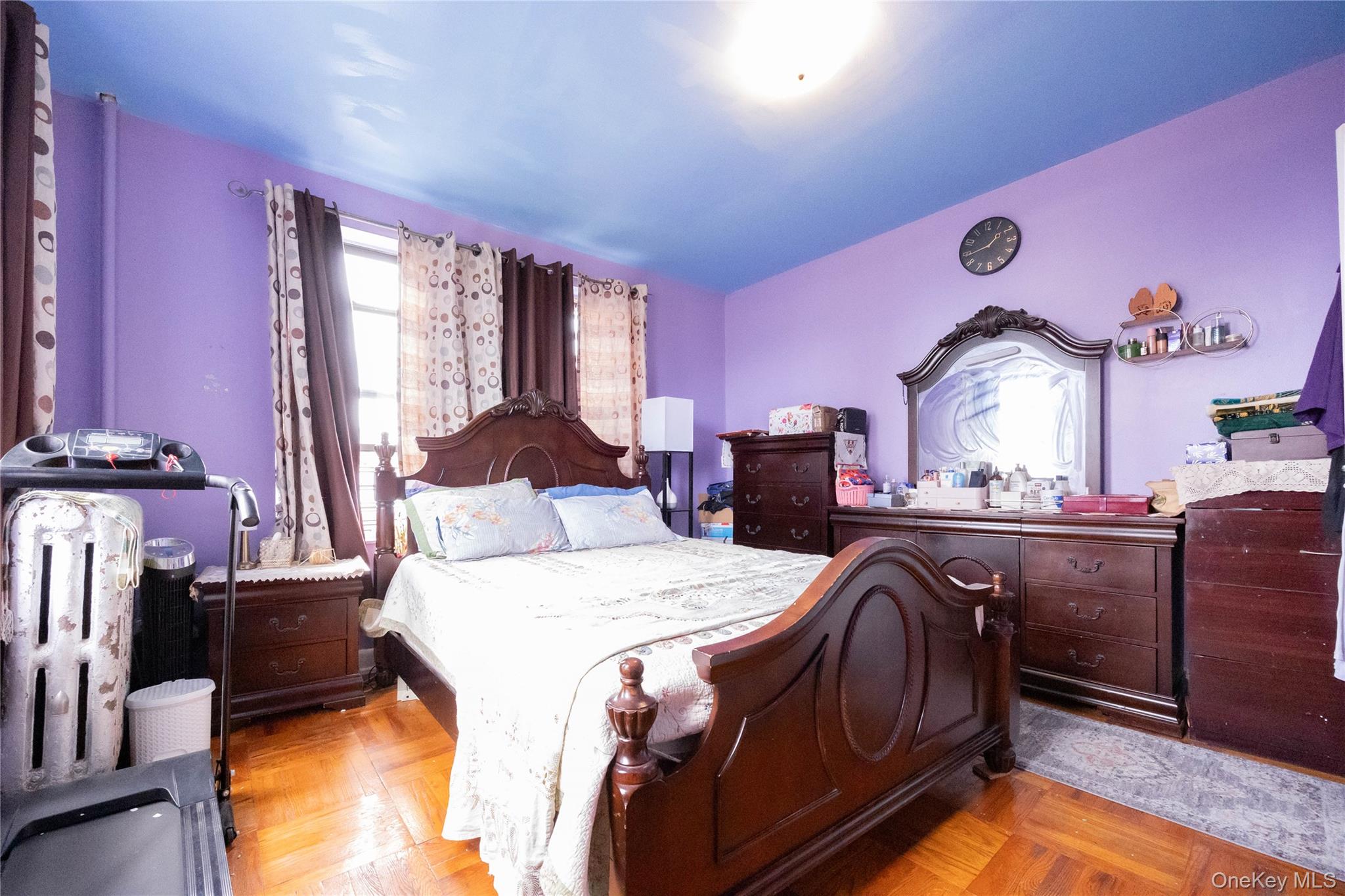 1506 Overing Street, Unit 6C Bronx, NY 10461 - Photo 6 of 16 a bedroom with a bed and dresser with mirror