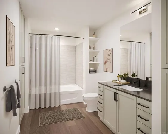 a bathroom with a double vanity sink a mirror a toilet and a bathtub