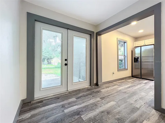 a kitchen with granite countertop white cabinets stainless steel appliances and a sink