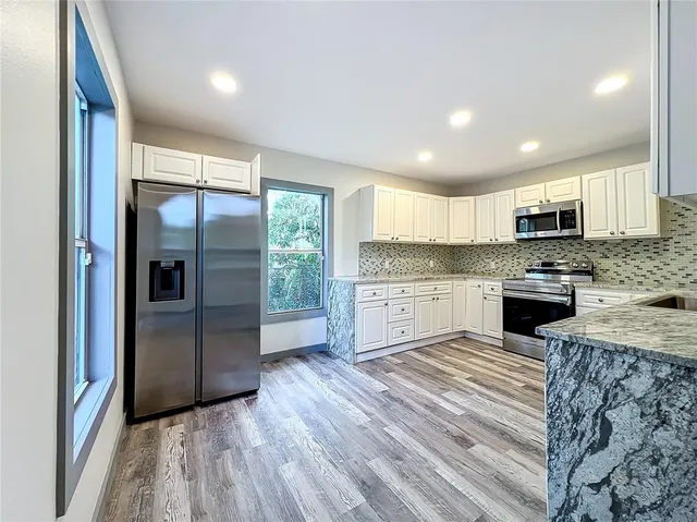 a view of a livingroom with wooden floor and closet