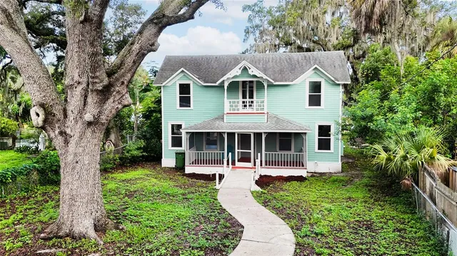 a front view of a house with a yard and balcony