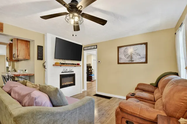 a living room with furniture a flat screen tv and a fireplace