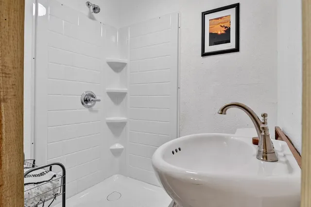 a bathroom with a white bath tub a sink and a toilet