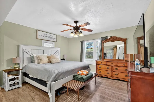 a bedroom with a bed and a chandelier