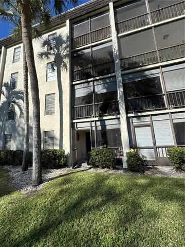 a building outdoor space with patio furniture and potted plants