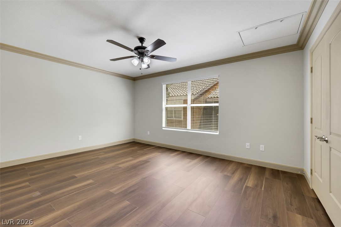 8101 West Flamingo Road, Unit 2136 Las Vegas, NV 89147 - Photo 18 of 32 Rich plank flooring and elegant crown molding elevate this versatile interior space.