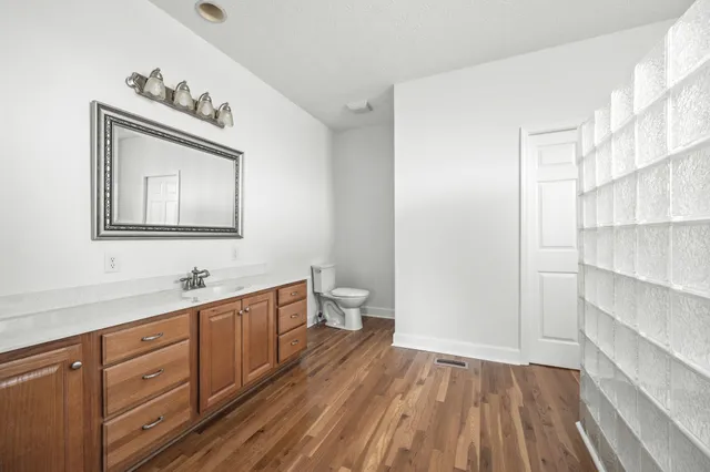 an empty room with a window and a ceiling fan