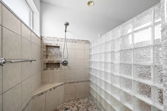 a living room with furniture a flat screen tv and a table