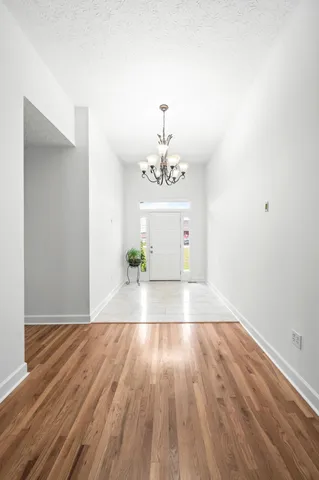 a kitchen with stainless steel appliances a sink a counter top space and living room view