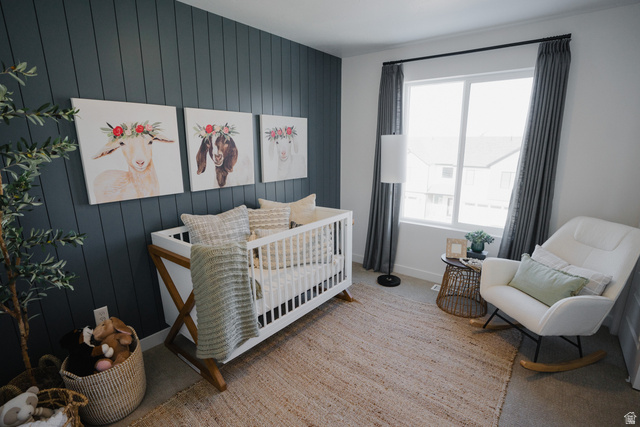 2012 West 1150 South, Unit 1018 Payson, UT 84651 - Photo 10 of 25 Bedroom featuring wood walls, a nursery area, light carpet, and an accent wall