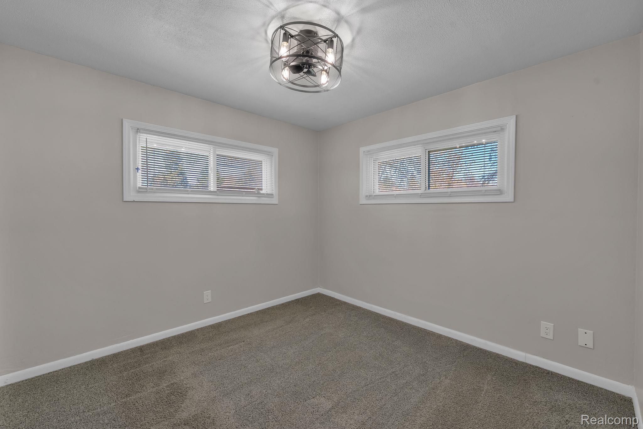 36845 Sibley Road New Boston, MI 48164 - Photo 18 of 22 Unfurnished room with dark colored carpet and healthy amount of natural light